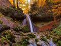 Waterfall in autumn with orange and yellow colors. Running clear, cold water in a forrest during autumn