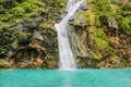 Waterfall in Ayn Khor  and Lush green landscape, trees and foggy mountains at tourist resort, Salalah, Oman Royalty Free Stock Photo