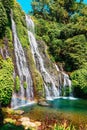 Waterfall with blue crystal water and rainbow in tropical island. Bali Royalty Free Stock Photo