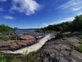 Waterfall Blue sky clouds streaming water Royalty Free Stock Photo