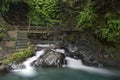 Waterfall and bridge at Gitgit waterfall. Royalty Free Stock Photo