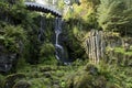 Waterfall and bridge in Park of Castle Wilhelmshoehe, Kassel, Germany. Scenic landscape