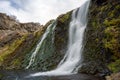 Waterfall cascade in the area of Gjain in Porsdalur in the Icelandic highlands. Overcast sky. Long exposure shot of the waterfall