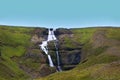 Waterfall cascade on a green hill