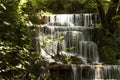 Waterfall. The cascade of waterfalls falls down between green trees