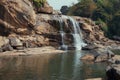 Waterfall Cascading into Serene Rocky Pool