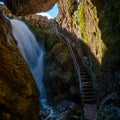 Waterfall in Cave Alongside Staircase