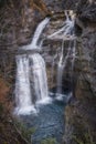 waterfall the Cave in the heart of the National Park of Ordesa and Monte Perdido, set in a rocky canyon, branches and small tree Royalty Free Stock Photo