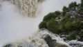 Waterfall close-up. Stormy streams of foaming water descend from the cliff. Royalty Free Stock Photo