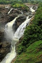 A waterfall in a cloudy tropical forest