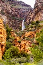 Waterfall coming down the colorful sandstone mountains in Oak Creek Canyon along Arizona SR89A between Sedona and Flagstaff