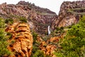 Waterfall coming down the colorful sandstone mountains in Oak Creek Canyon along Arizona SR89A between Sedona and Flagstaff Royalty Free Stock Photo