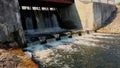 Waterfall on damm of small river. gateway lock construction.