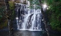 Waterfall with dancing fairy lights in enchanted forest Royalty Free Stock Photo