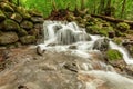 Waterfall in a deep green forest Royalty Free Stock Photo