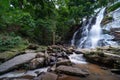 Waterfall in the deep rain forest jungle, Beautiful waterfall in green tropical forest. View of the falling water with splash in Royalty Free Stock Photo