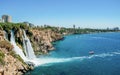 Waterfall Duden at Antalya turkey top view on the mountain with coast ferry boat on blue sea and harbor city background - Royalty Free Stock Photo