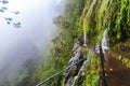 Waterfall falling on the walking trail along a levada in the mountains of Madeira, Portugal Royalty Free Stock Photo