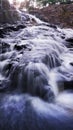 Waterfall flow with super smooth water and a stretch of rocks