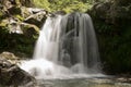 Waterfall flowing in a hidden place in a green peaceful place