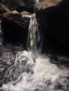 Waterfall flowing over Huge rocks Royalty Free Stock Photo