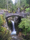 Waterfall under a stone bridge