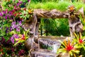 Waterfall flows in cozy home flower garden Royalty Free Stock Photo