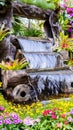 Waterfall flows in cozy home flower garden Royalty Free Stock Photo