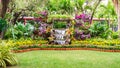 Waterfall flows in cozy home flower garden Royalty Free Stock Photo