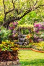 Waterfall flows in cozy home flower garden Royalty Free Stock Photo