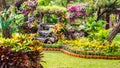 Waterfall flows in cozy home flower garden Royalty Free Stock Photo