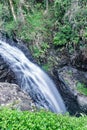 Waterfall flows down on the mountain through the jungle Royalty Free Stock Photo