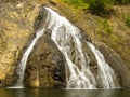 Waterfall flows down over rock