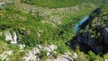 The waterfall flows into the river canyon