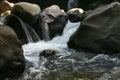 Waterfall in the forest with rock and stone in the foreground. Royalty Free Stock Photo