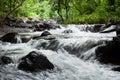 Waterfall from a forest stream with moss covered rock