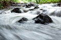 Waterfall from a forest stream with moss covered rock