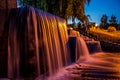 Waterfall and fountains in neon lighting of city lanterns