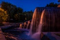 Waterfall and fountains in neon lighting of city lanterns