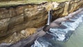 Waterfall on Golovinsky Cliff on Kunashir Island, Kuril Islands, Russia. Aerial photography Royalty Free Stock Photo