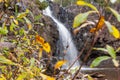 Waterfall in Gooseberry Falls State Park Minnesota, framed by autumn leaves. Blurred long exposure Royalty Free Stock Photo