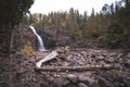 Waterfall in Gooseberry Falls State Park Minnesota, large driftwood in foreground Royalty Free Stock Photo