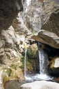 Waterfall in the gorge from under the stone. Tien Shan Royalty Free Stock Photo