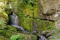 Waterfall And Green Mossy Rocks