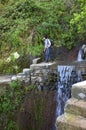 Waterfall and hiker in mountain landscape Madeira