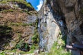 Waterfall on the hiking trail to the tiger nest in Bhutan, Himalaya. The water falls down the rock. A traditional monastery on a