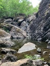 Waterfall. Huge gray boulders in the forest