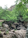 Waterfall. Huge gray boulders in the forest