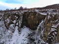 Waterfall Hundafoss (height 24m) in Skaftafell national park in the south of Iceland near ring road in winter with snow. Royalty Free Stock Photo