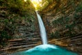 Waterfall `Lace` in the mountains illuminated by the sun. Waterfall in the mountains illuminated by the sun. Gelendzhik, North Cau